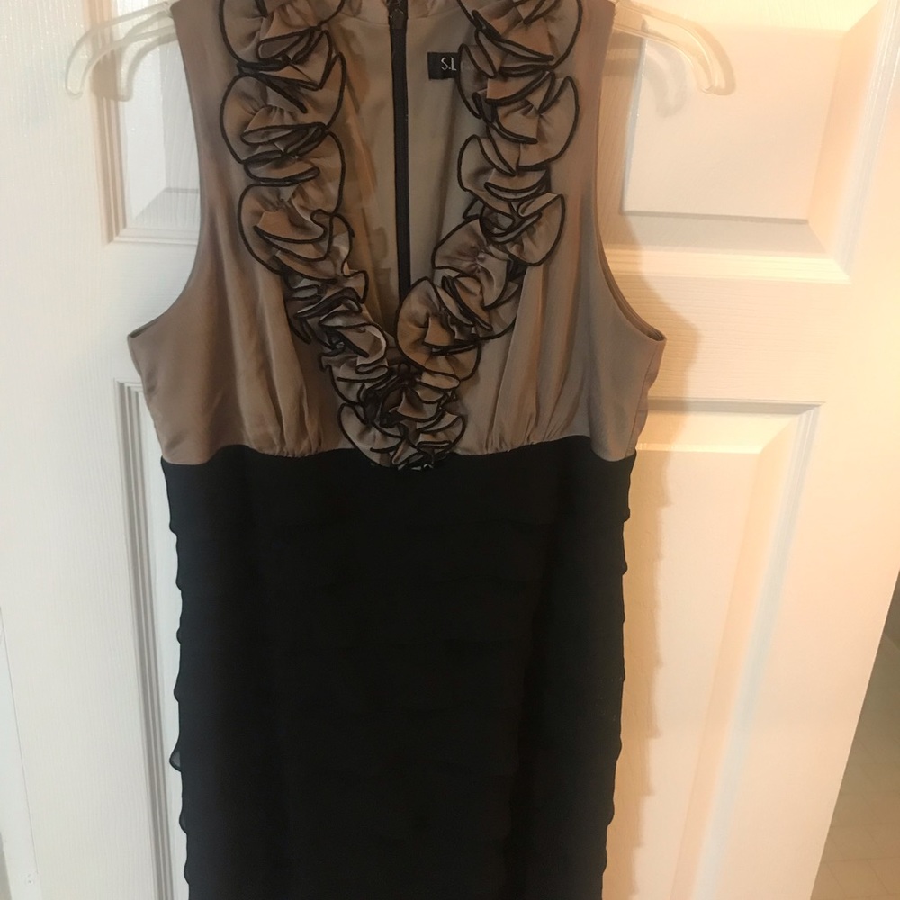 Tiered dress with ruffles around the collar.